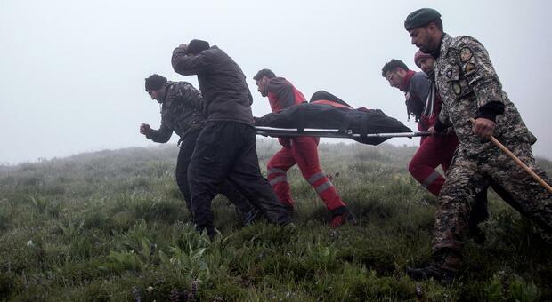 epaselect epa11354945 Iranian rescue workers carry the bodies of the victim of the crashed Iranian President helicopter, in the area of Varzaghan, Tabriz province, southwestern Iran, 20 May 2024. According to Iranian state media, President Raisi,...