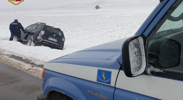 Auto fuori strada nella tormenta di neve: automobilisti soccorso della polizia