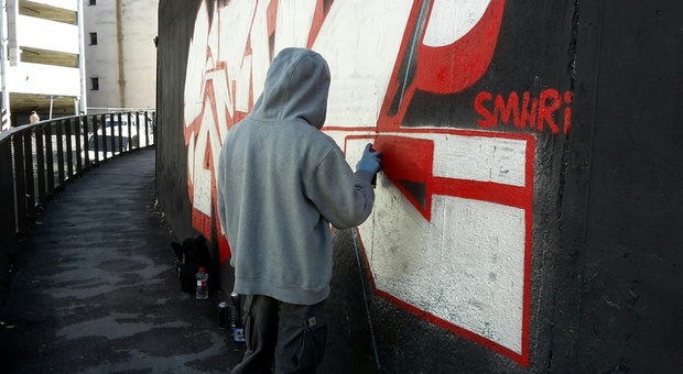 Terni, i genitori cancellano le scritte sul muro fatte da figli minorenni dopo l'intervento dei carabinieri
