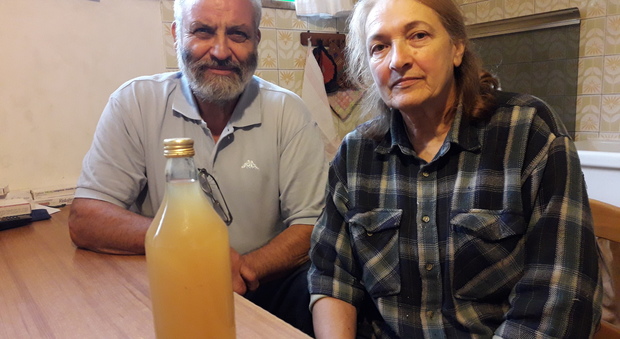 I coniugi Revelant con una bottiglia di acqua sporca nella loro casa di Adorgnano di Tricesimo