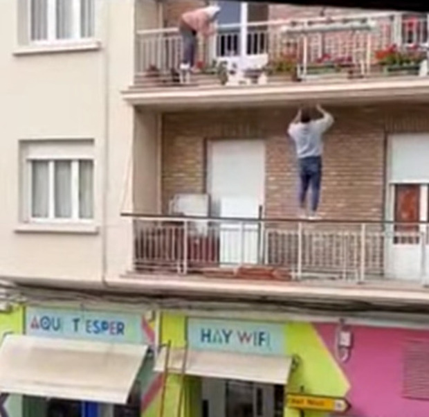 Un giovane si arrampica sulla facciata di un palazzo per salvare un'anziana che sta per cadere da un balcone - VIDEO
