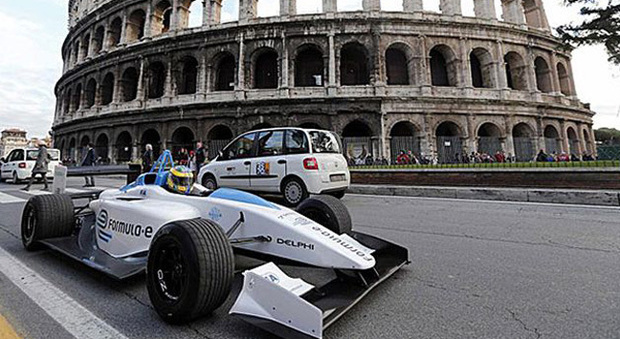 Una vecchia monoposto di Formula E transita a Roma con sullo sfondo il Colosseo