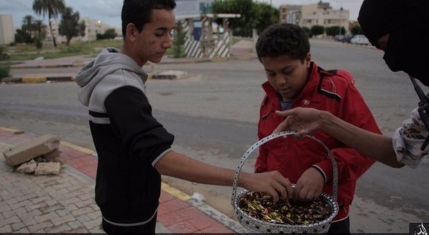 L'Isis festeggia dopo gli attentati di Parigi: caramelle in strada ai passanti in Libia