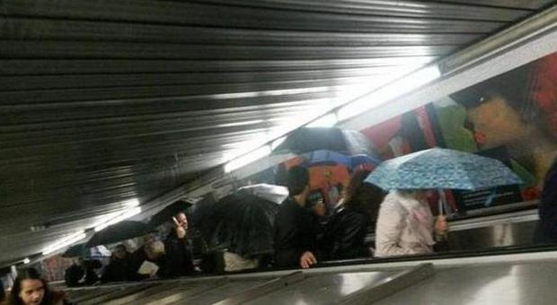 Passeggeri della metro A con gli ombrelli nella stazione di Repubblica