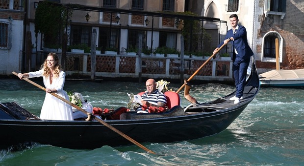 Venezia, gondolieri sposi arrivano al ricevimento di nozze vogando con gli abiti della cerimonia