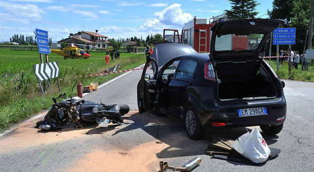 Motociclista centra un'auto, abbatte un cartello con il corpo e "vola" in canale: è gravissimo