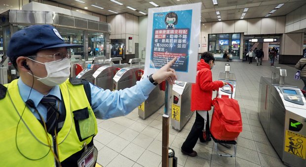 Un cartello indica l'obbligo di indossare la mascherina in una stazione della metro di Taiwan