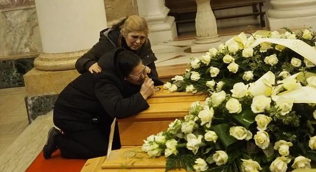 La disperazione di una parente dei fratelli morti al funerale dei tre giovani