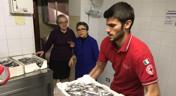 La Croce Rossa consegna il pesce avuto in dono alla mensa del povero
