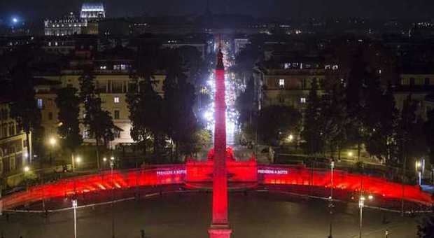 Roma, piazza del Popolo si illumina di rosso per dire no alla violenza sulle donne