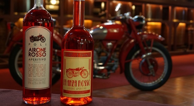 Realta' e finzione. Nell'immagine le due bottiglie fotografate all'interno delle distillerie Poli. Sullo sfondo la Guzzi Airone che ha ispirato il finale della fiction. (Foto Poli Distillerie)