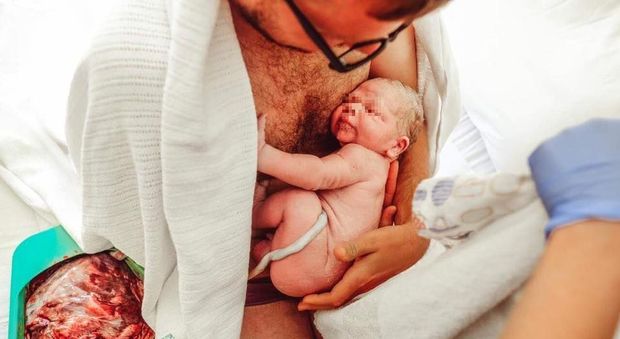 Il padre abbraccia il neonato, ma la foto fa discutere su Facebook: ecco perché