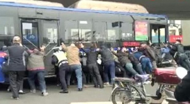 Rimane intrappolato sotto il bus: i passeggeri spostano il mezzo per liberarlo