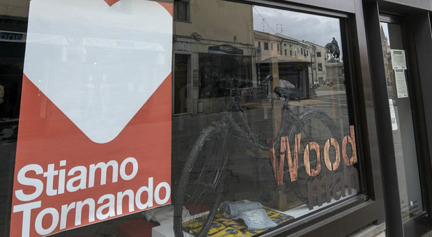 I cartelli in centro a Rovigo che annunciano la riapertura dei negozi