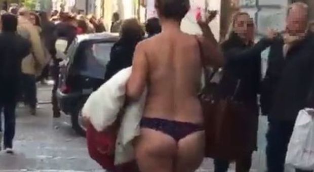 Napoli, il mistero della donna seminuda: cammina e provoca i passanti in strada | Guarda il video