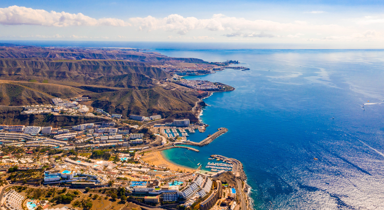 https://statics.cedscdn.it/photos/MED_HIGH/2026/08/17/9711227_17131124_fascinating_aerial_view_gran_canaria_island_near_amadores_beach_with_crystal_clear_water_bay.jpg
