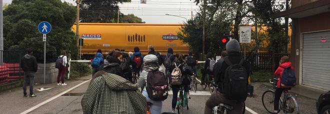 Studenti in coda in attesa del passaggio a livello. Accade sempre più spesso che qualcuno decida di tagliare i tempi attraversando a sbarra abbassata Studenti in coda in attesa del passaggio a livello. Accade sempre più spesso che qualcuno decida di tagliare i tempi attraversando a sbarra abbassata