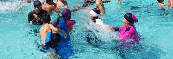 Donne musulmane in piscina col burkini per protesta contro il divieto: multate