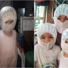 Filippine, mascherine finite: bimbi con i pannolini sul viso per le polveri del vulcano