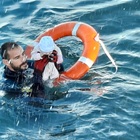 Migranti, la foto del militare che salva un neonato in mare simbolo della crisi in Spagna